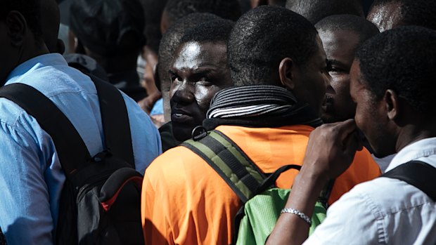 Migrants are detained by French police after being evacuated from the Panthenon in Paris.