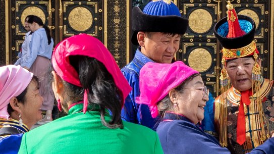 People take selfies in front of a museum in Mongolia’s capital.