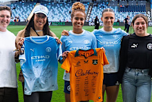 Mary Fowler and Kerstin Casparij with Wallaroos players.