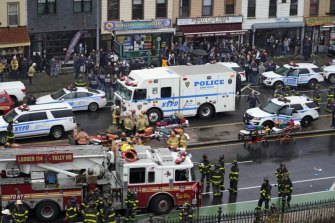 Emergency personnel gather at the entrance to a subway stop in the Brooklyn borough of New York after the shooting.