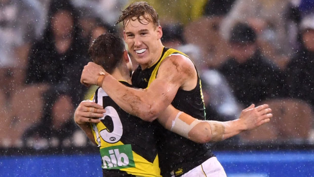 Tigers Tom Lynch (right) and Jayden Short embrace during Richmond's win over Collingwood last night.
