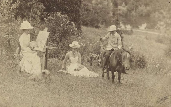 Ellis Rowan (left) sketches Mary Moule circa 1880s. A dog sits at Rowan’s feet and son Eric rides a pony.