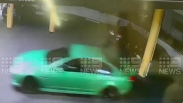 The green Holden sedan speeds away seconds after the shooting inside the vehicle.