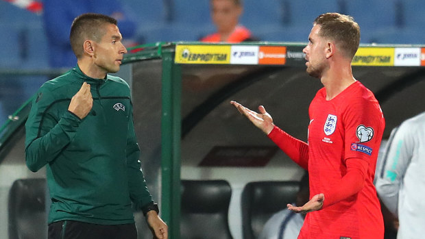 England's Jordan Henderson complains to a match official during the game.