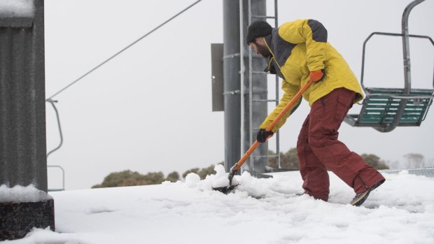 Snow is shovelled at Thredbo after a 5cm fall at the weekend.