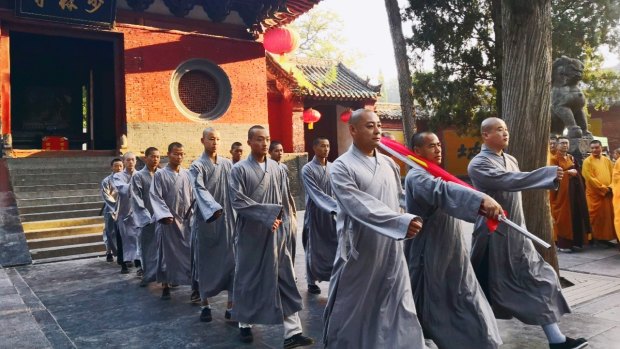 Monks from the Shaolin Temple prepare for the flag raising ceremony.