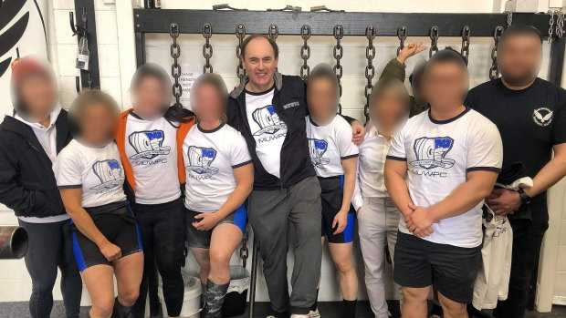 Powerlifting Australia’s national coaching director Robert Wilks, centre, has launched defamation proceedings against once of his female students.  