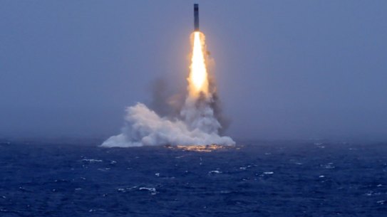 An image published by Chinese state media shows a missile launched from a submarine in the South Pacific.