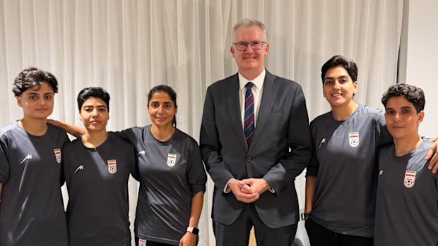 Minister for Home Affairs Tony Burke with five Iranian women soccer players who were granted asylum in Australia on Monday night.