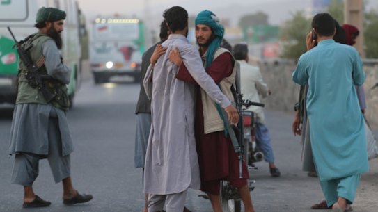 A Taliban soldier frisks someone at a checkpoint in Herat. 