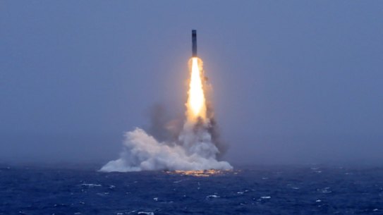 An image published by a Chinese state media outlet shows a missile being launched from a submarine in the South Pacific.