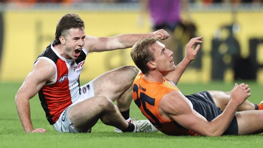 Jack Higgins reminds Lachlan Keeffe about one of his goals.