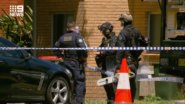 Police negotiators are at Gladesville a unit where an officer was slashed on the head. 