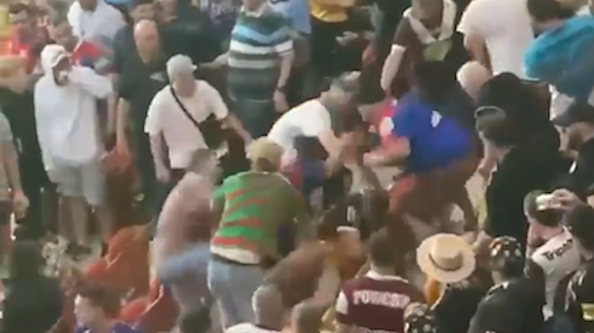 Spectators brawl during the Broncos-Manly game of the NRL Magic Round at Suncorp Stadium in Brisbane on Friday night.