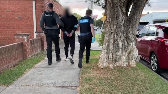 An Airport West man is led away by police on Monday.