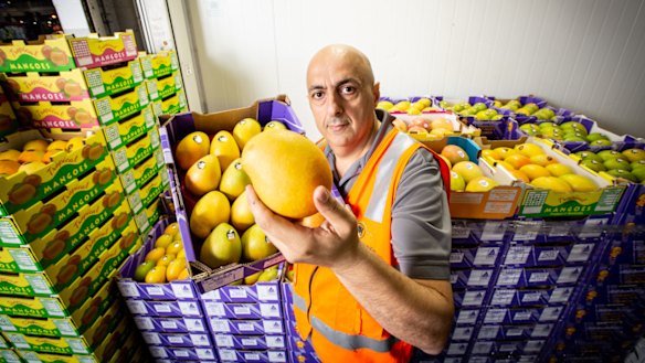 Sam Haddad from HE Heather and Co with his mangoes at Brisbane Markets. 