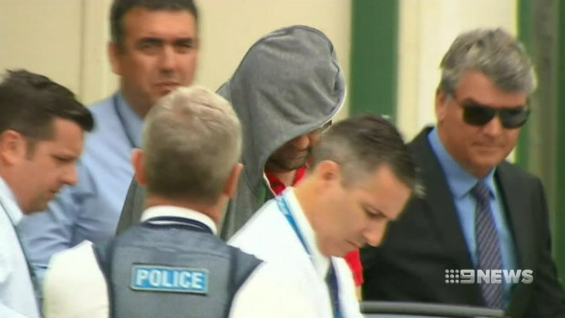 Bradley Edwards on the day of his arrest being escorted out of his Kewdale home by Macro Detectives Joseph Marrapodi (top left) and Aaron Capes.