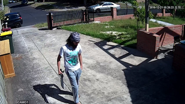 Chaarani walking up his Dallas driveway with a machete.