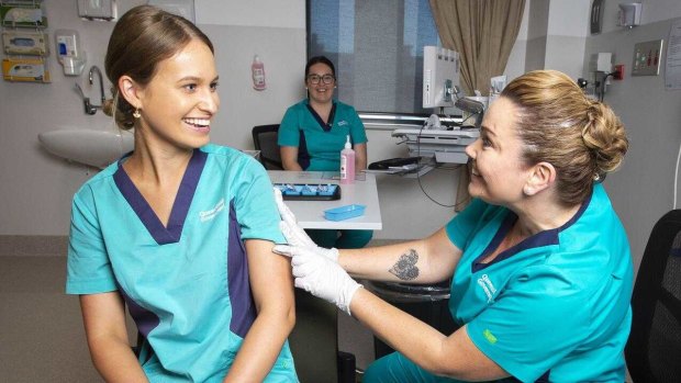 Queensland nurse Zoe Park receives a COVID-19 vaccination from Kellie Kenway at Gold Coast University Hospital on Monday.