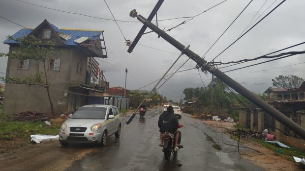 A man in Puerto Cabezas, Nicaragua,  rides his motorbike along a road damaged by Hurricane Iota.