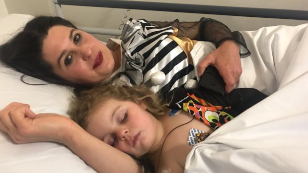 Three-year-old Abby recovering in hospital with her mother Tara.