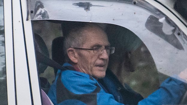 Ronald Doyle, seen leaving his Brisbane house,  is alleged to have helped his sons deal with proceeds of share sales. 