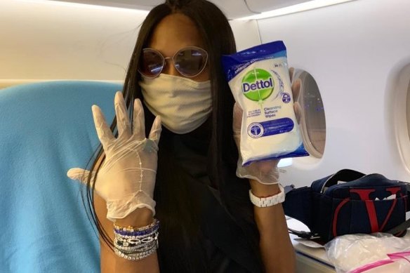 Naomi Campbell and her ever faithful disinfectant wipes as she bravely flies first class during the COVID-19 pandemic.