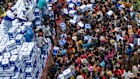 Displaced Cambodians receive water at the Battkhao Resettlement Camp as a border clash continued.