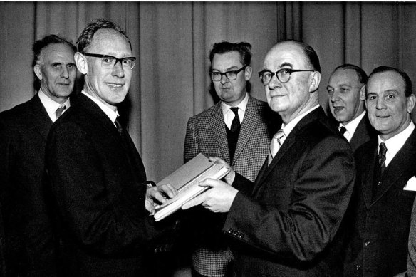 Tony (left) receiving an album of his photos from the New Earswick Camera Club. 