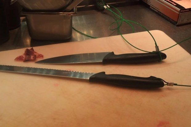 kitchen knives tethered to a bench