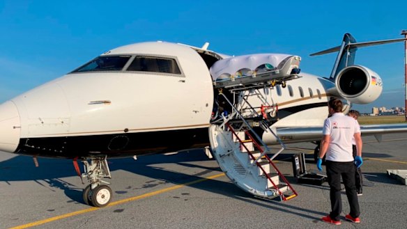 Alexei Navalny loaded on a plane in Omsk, Russia.