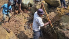 Villagers search through a landslide in Yambali, in the Highlands of Papua New Guinea. 