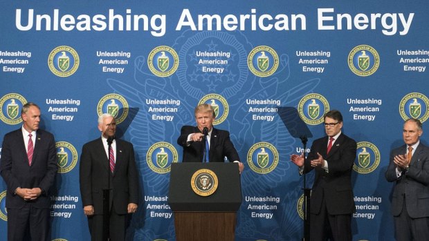 US President Donald Trump, centre, with Scott Pruitt, far right,  has sought to turn the focus away from fighting climate change and toward American "energy dominance".
