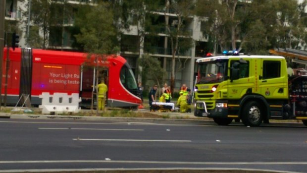 Emergency services tend to a pedestrian after they were hit by a tram on Canberra's light rail network.