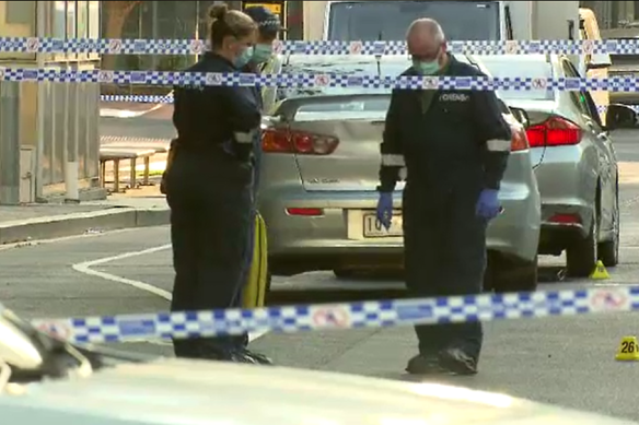 Officers look for evidence at the site of the alleged double stabbing in Docklands. 