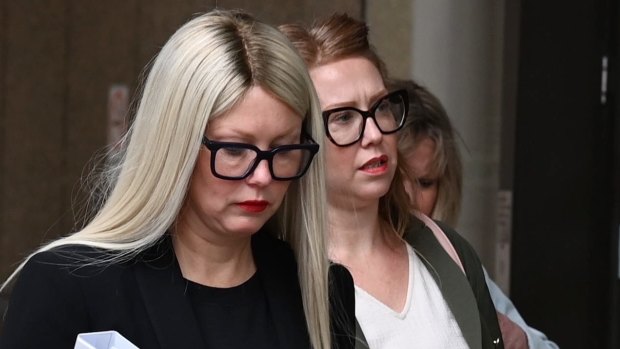 Elaine Stead with her sister Olivia behind entering the Federal Court in Sydney where she is suing the AFR.