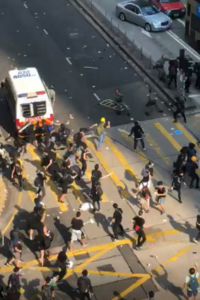 Protesters swarm a police van in Hong Kong on Tuesday.