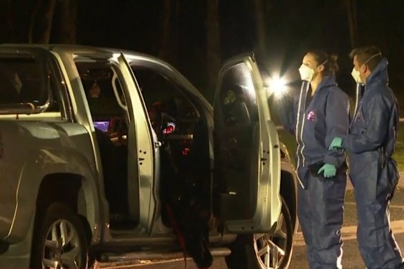 Police officers gather evidence in the foot scene.