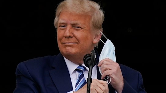 Donald Trump removes his mask to speak. 