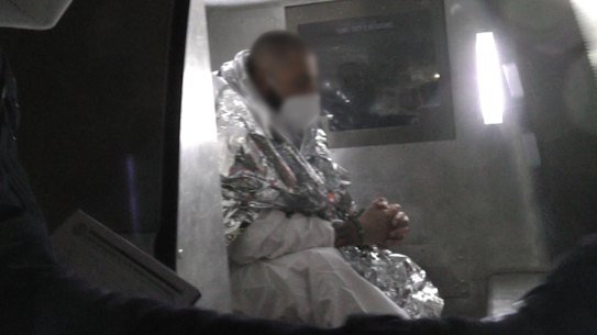 Two of the men under police guard after their arrest.