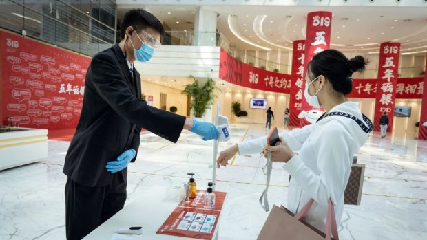 At e-commerce giant JD.com’s headquarters in Beijing, employees have their temperature screened and the building is disinfected three times a day.