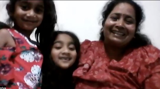 A tearful Priya Murugappan celebrates with daughters Kopi and Tharni on hearing the news that they can return to Biloela after Labor won the election.