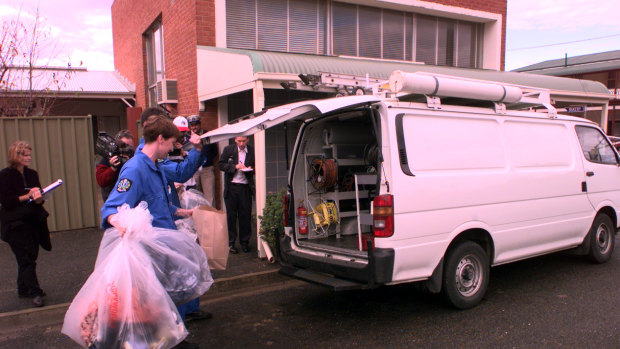 Police Technical  Services Officers remove items from former bank building in Snowtown.