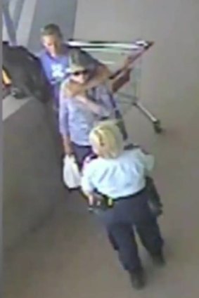 CCTV footage shows the dramatic image of David Clarke holding a knife to the back of a 75-year-old woman, while a police officer intervenes, at a shopping centre in Morisset.