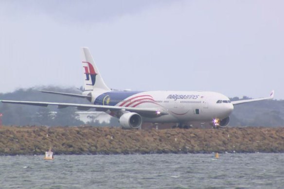 Malaysia Airlines flight MH122 sitting on the runway at Sydney Airport.