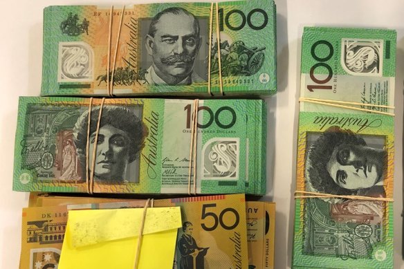 A pile of cash allegedly found in the man's Waterloo apartment. 