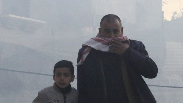 Palestinians flee after an Israeli strike on a residential building in Rafah on Monday. 