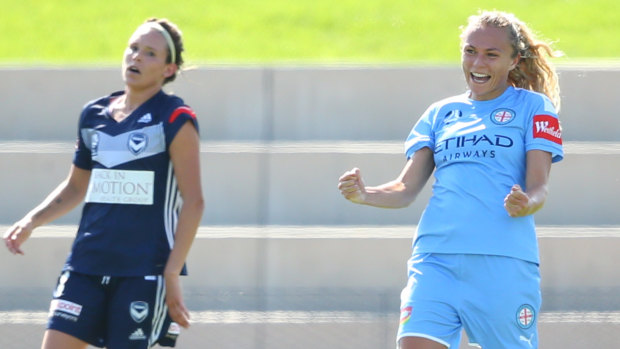 On the double: Melbourne City's Scottish striker Claire Emslie (right) is overjoyed after firing in a brace against Victory.
