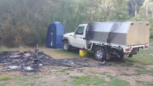 Russell Hill’s Toyota LandCruiser and the burnt campsite at Bucks Camp.