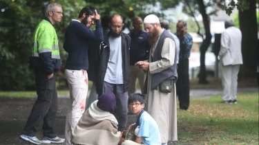 Stunned and bloodied workshippers outside one of the Christchurch mosques.